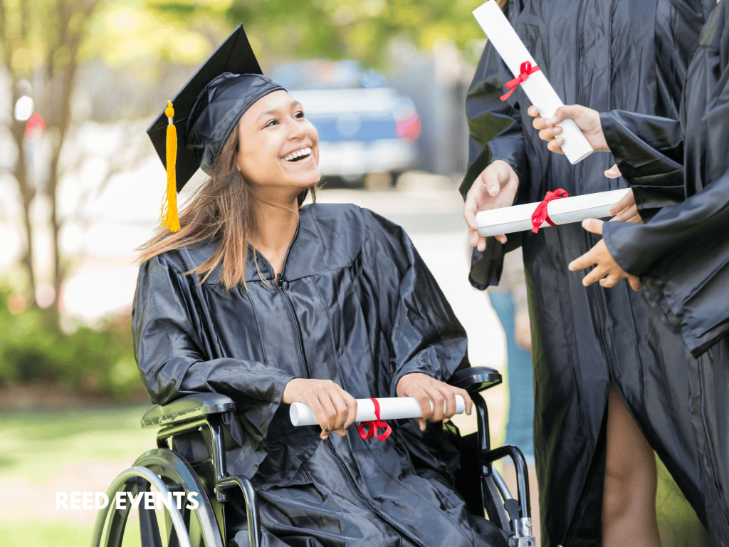 A girl in a graduation dress is sitting in a wheelchair